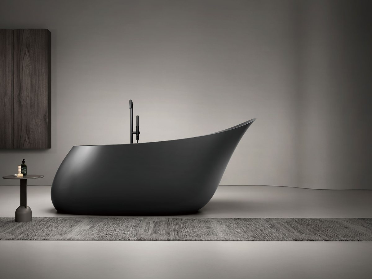Compact upright soaking tub with floor-standing filler and stool