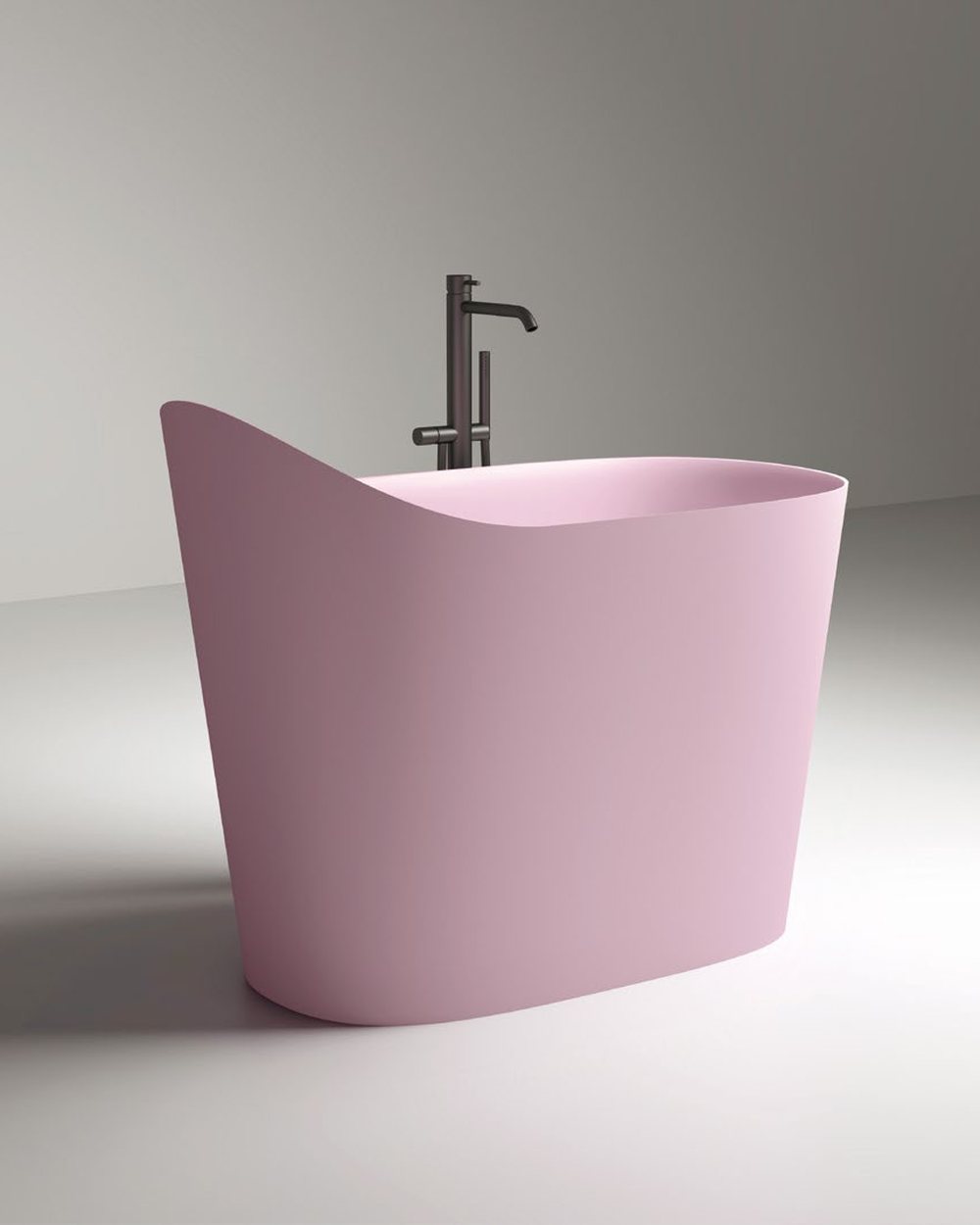 Compact oval soaking tub on a stone platform