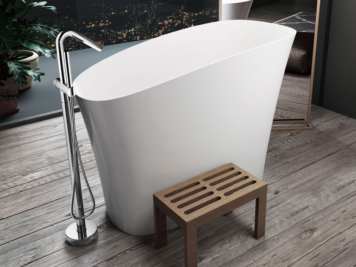 Compact upright soaking tub with floor-standing filler and stool
