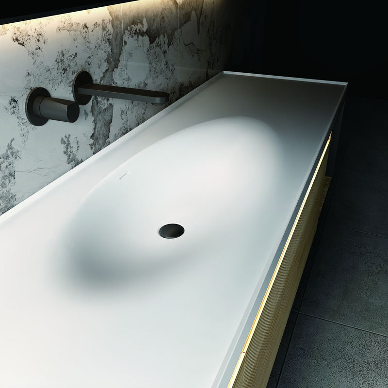 Integrated basin bowl and drain position on a vanity top