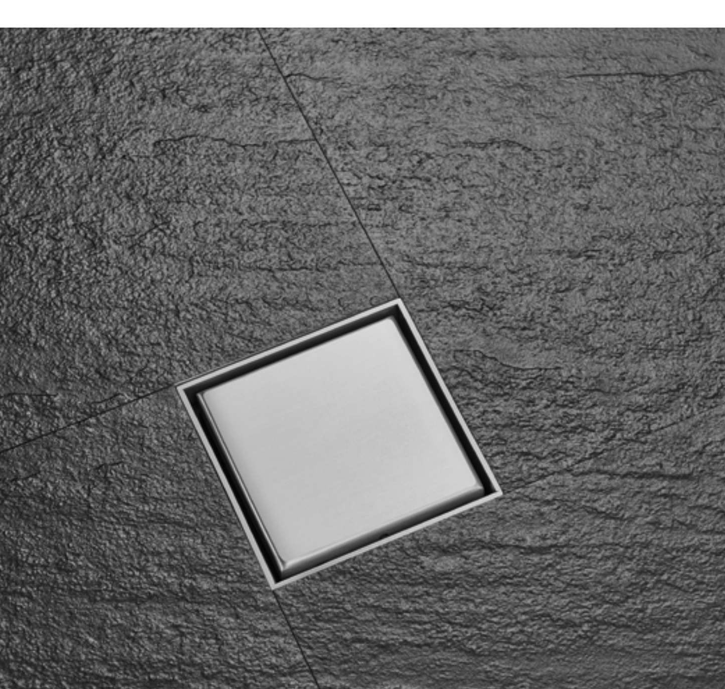 Square tile-insert floor drain set into a slate floor