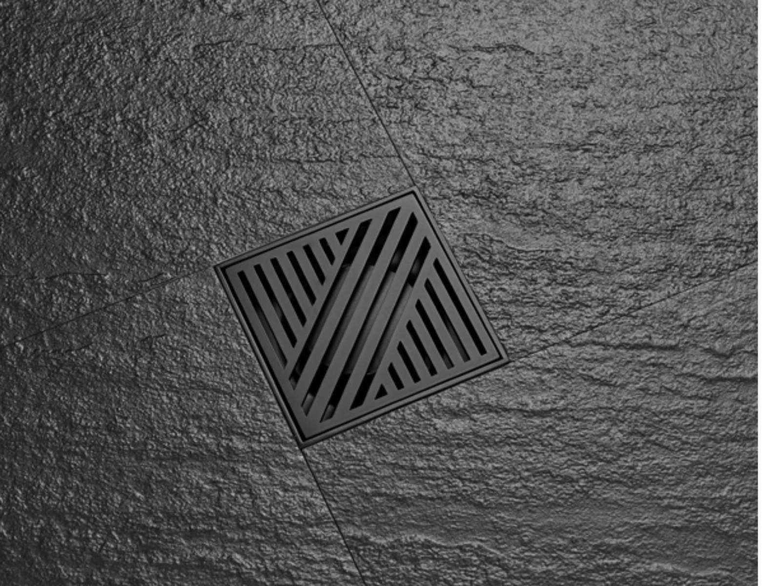 Square floor drain with a patterned stainless grate