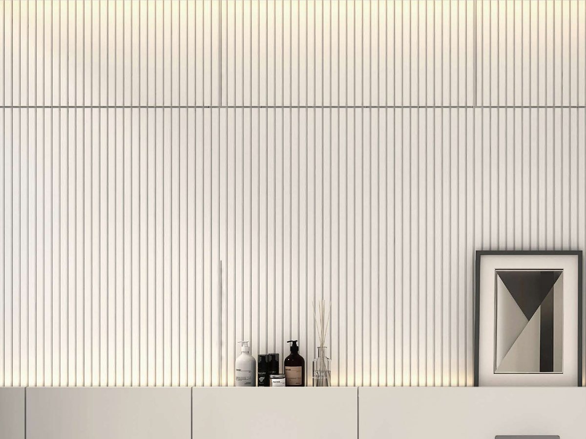 A fluted wall panel above a light-toned vanity counter