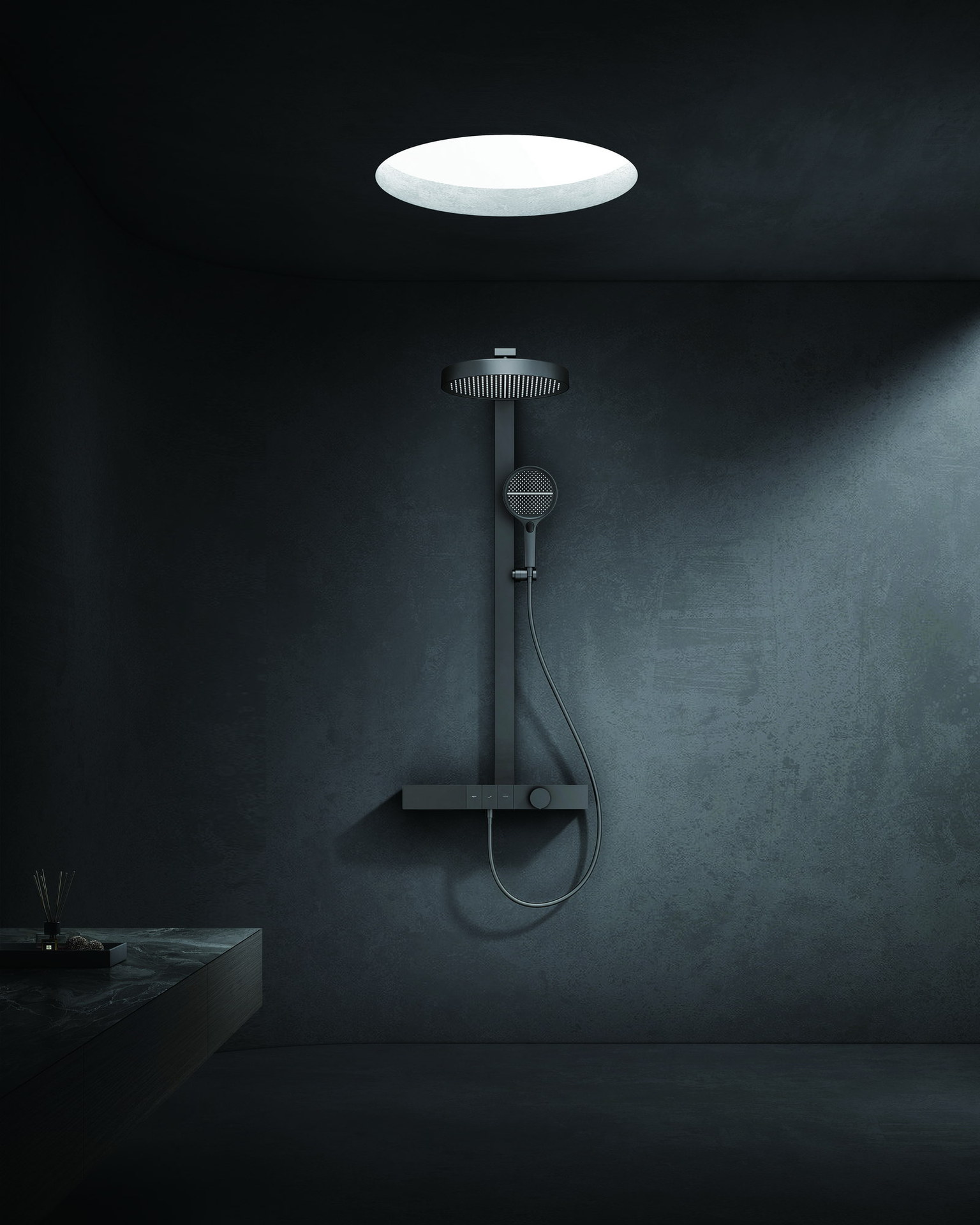 Ceiling-mounted rain shower head above a dark tiled shower area