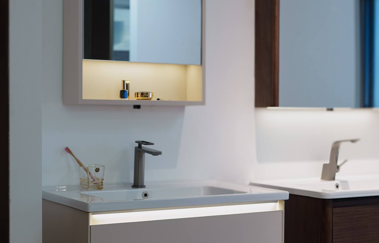 A white wall-mounted vanity with a tall basin tap